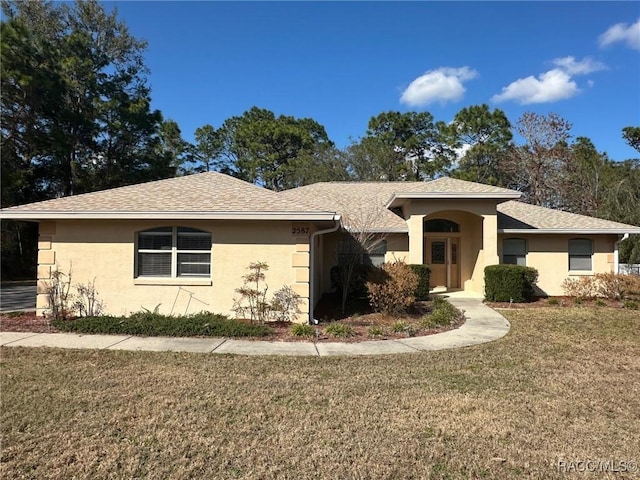 ranch-style home with a front lawn