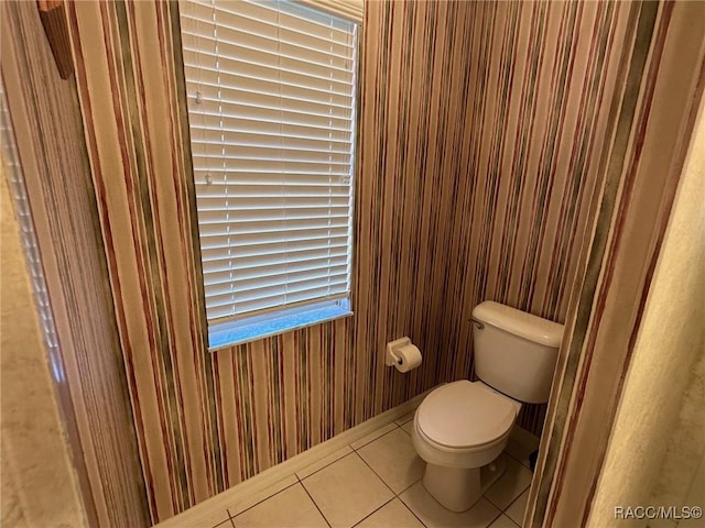 bathroom featuring toilet and tile patterned flooring