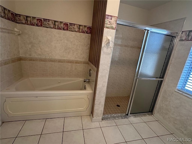 bathroom with tile patterned flooring and shower with separate bathtub