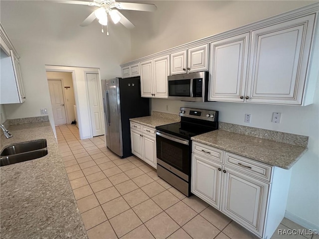 kitchen featuring ceiling fan, appliances with stainless steel finishes, sink, and white cabinets