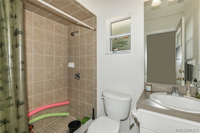 bathroom with a shower with shower curtain, vanity, and toilet