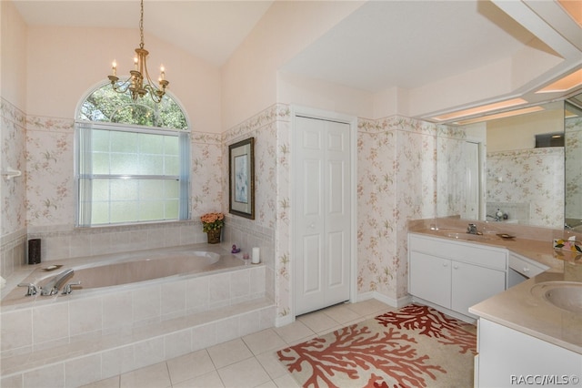 bathroom with vanity, lofted ceiling, tile patterned floors, tiled bath, and a chandelier