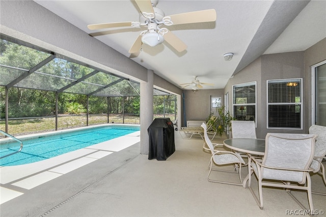 view of swimming pool featuring a patio, ceiling fan, and a lanai