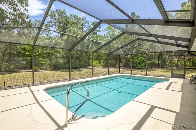 view of swimming pool with a patio area and glass enclosure