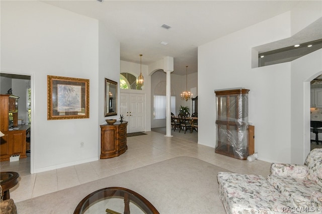 tiled living room with a chandelier