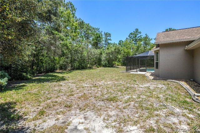 view of yard featuring glass enclosure