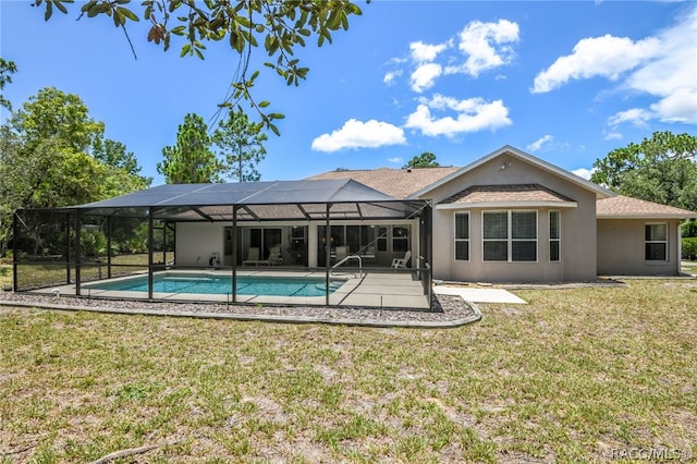 rear view of house featuring a lawn and glass enclosure