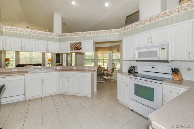 kitchen featuring white cabinetry, light tile patterned floors, high vaulted ceiling, and white appliances