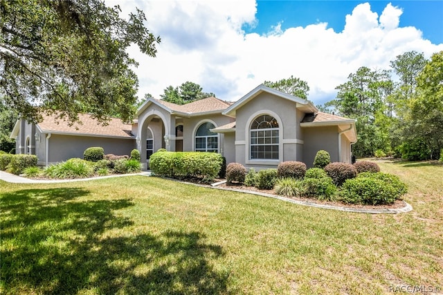 mediterranean / spanish home with a front yard