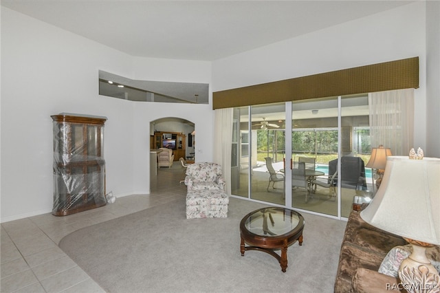 living area featuring tile patterned floors and ceiling fan