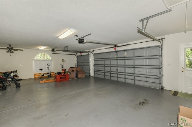 garage with ceiling fan and a garage door opener