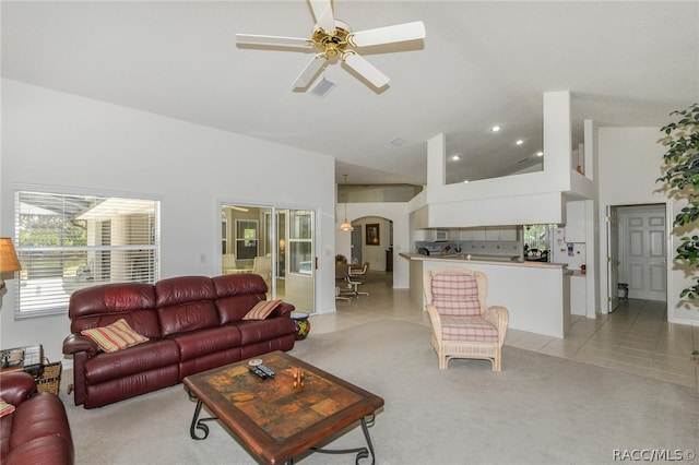 living room featuring ceiling fan, light tile patterned flooring, and high vaulted ceiling