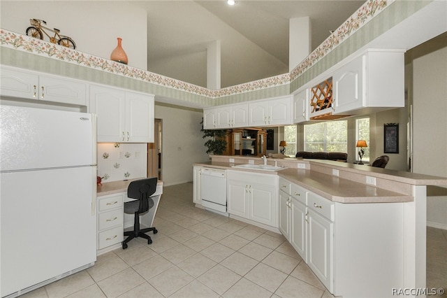 kitchen featuring white appliances, high vaulted ceiling, white cabinets, light tile patterned floors, and kitchen peninsula