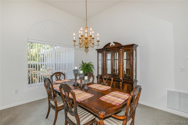 dining area with carpet, a notable chandelier, and vaulted ceiling