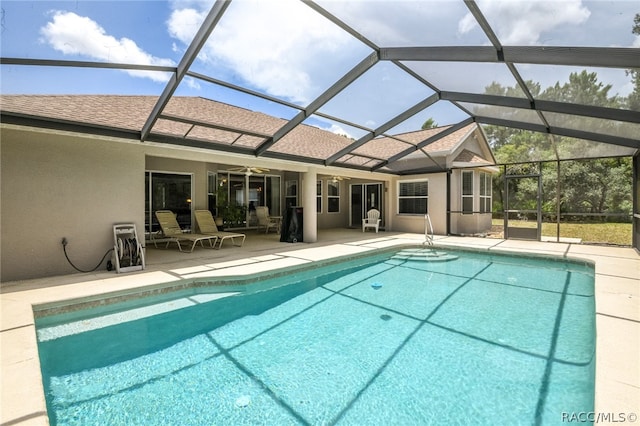 view of pool with a patio, ceiling fan, and a lanai