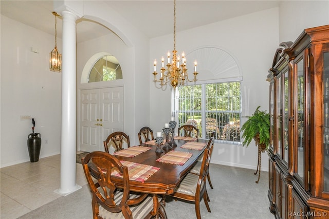 dining area featuring decorative columns, vaulted ceiling, plenty of natural light, and light colored carpet