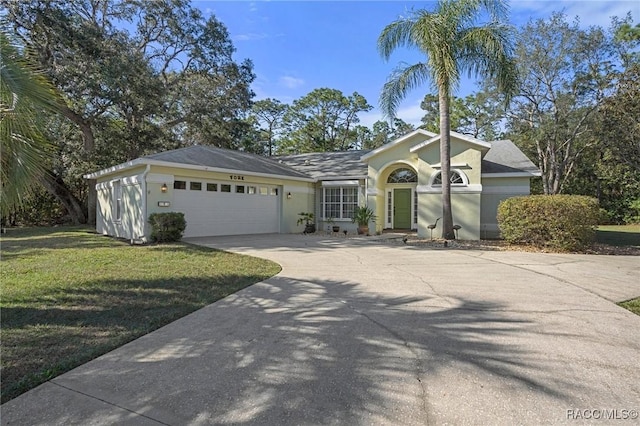 ranch-style house with a garage and a front yard