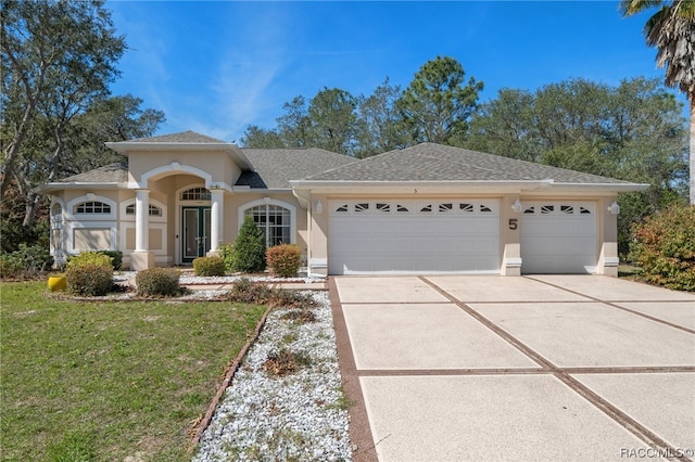 view of front of home featuring a garage and a front lawn