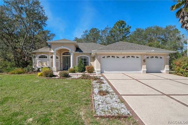 view of front of property featuring a garage and a front lawn