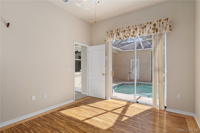 spare room with wood-type flooring