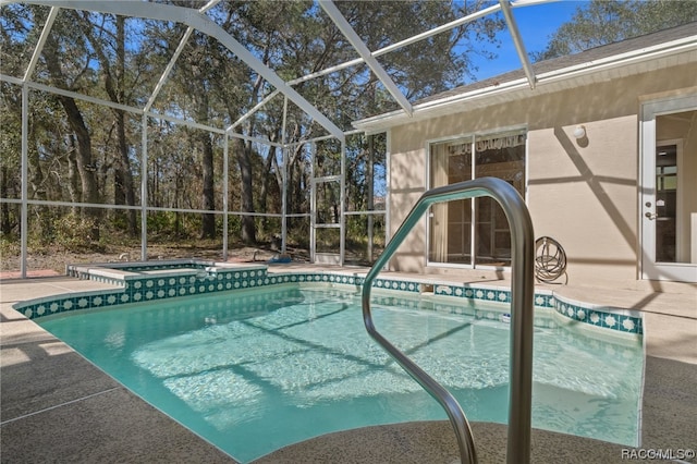 view of swimming pool with an in ground hot tub, glass enclosure, and a patio area