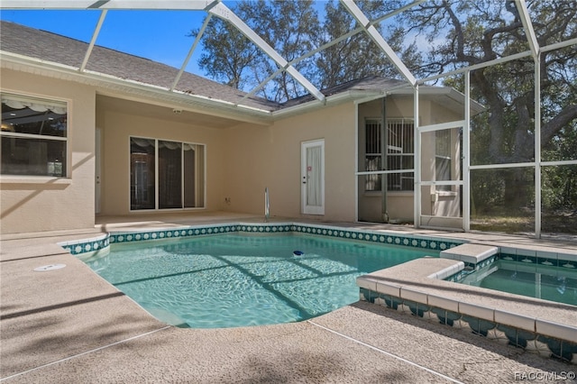 view of pool with a lanai, an in ground hot tub, and a patio