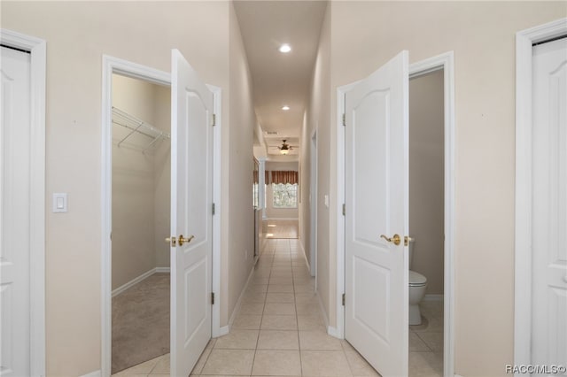 hall featuring light tile patterned floors