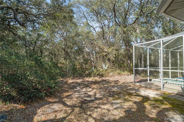 view of yard with glass enclosure