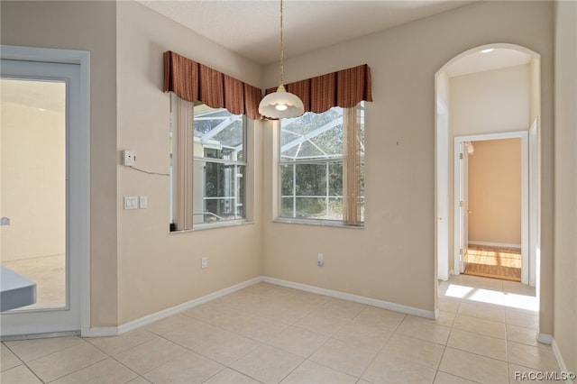 unfurnished dining area featuring light tile patterned floors