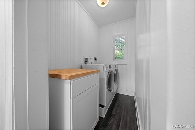 laundry area with laundry area, washing machine and dryer, and dark wood-style flooring