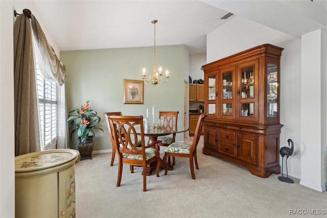 dining room featuring an inviting chandelier and light colored carpet