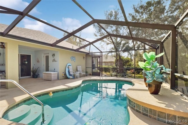 view of pool featuring a patio area and glass enclosure