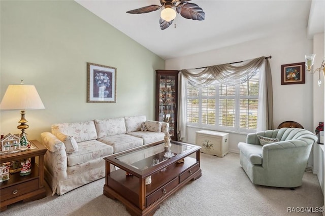 carpeted living room featuring vaulted ceiling and ceiling fan