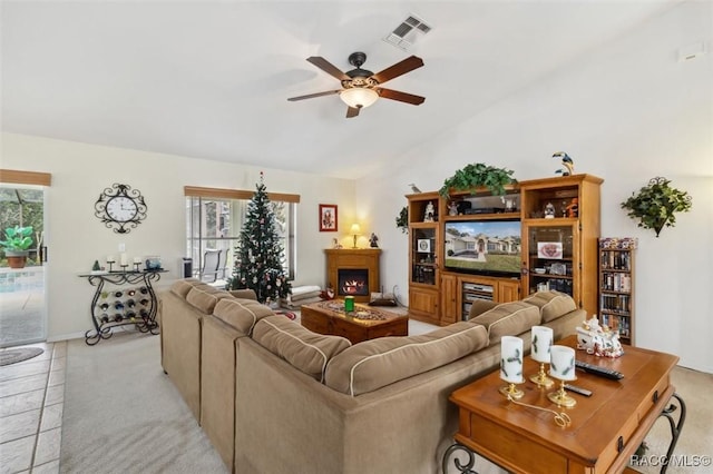 living room featuring plenty of natural light, ceiling fan, and light carpet