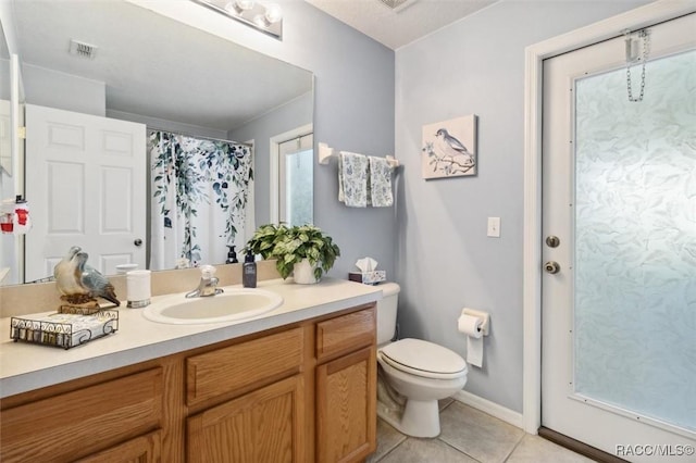 bathroom with tile patterned floors, toilet, and vanity