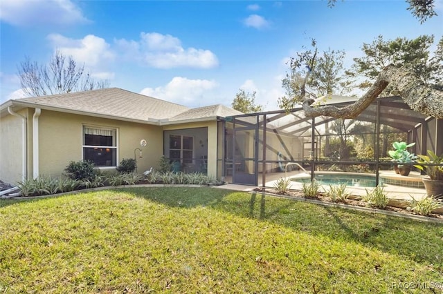 exterior space with a yard and glass enclosure