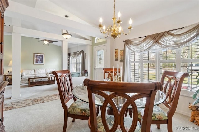 dining room with light carpet, ceiling fan with notable chandelier, and vaulted ceiling