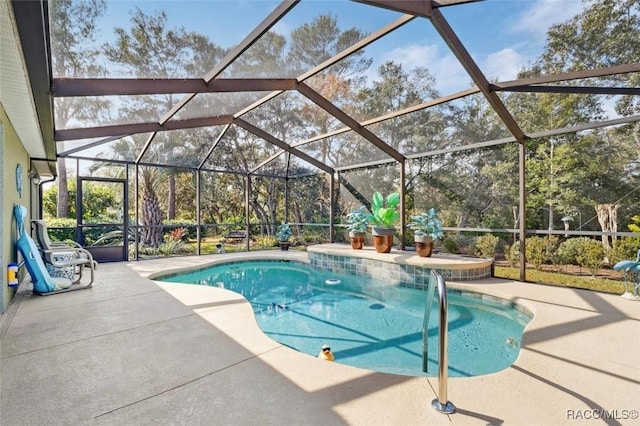 view of swimming pool with a patio and a lanai