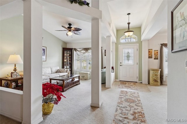 carpeted foyer featuring a high ceiling and ceiling fan