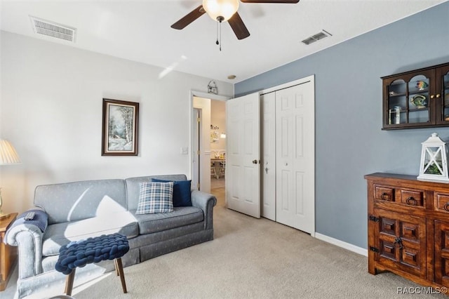 living room featuring light carpet and ceiling fan