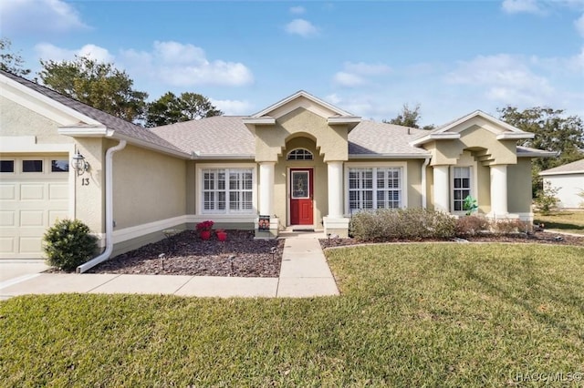 view of front of property with a garage and a front lawn