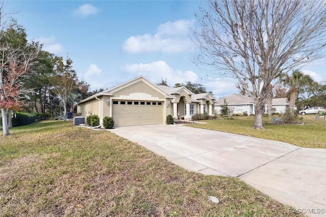 ranch-style house with central AC, a garage, and a front lawn