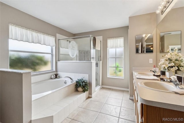 bathroom with tile patterned flooring, vanity, and shower with separate bathtub