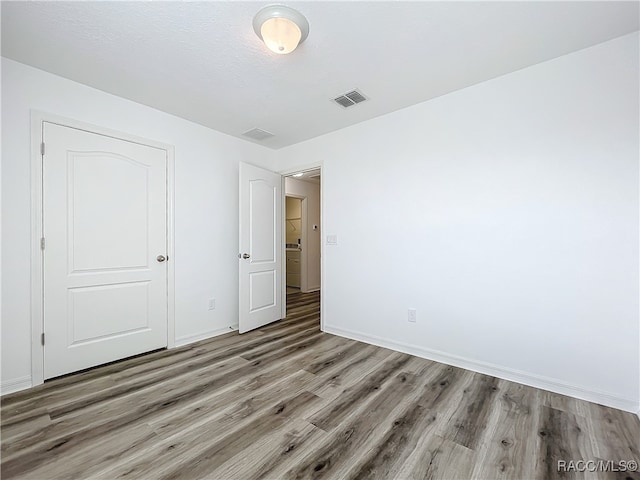 spare room with hardwood / wood-style flooring