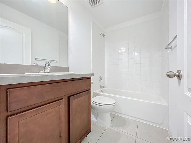 full bathroom with tiled shower / bath, tile patterned flooring, vanity, and toilet