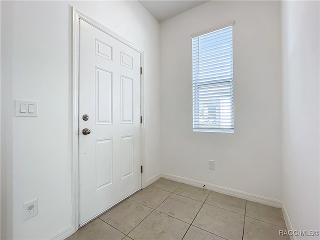 doorway to outside featuring a wealth of natural light and light tile patterned flooring