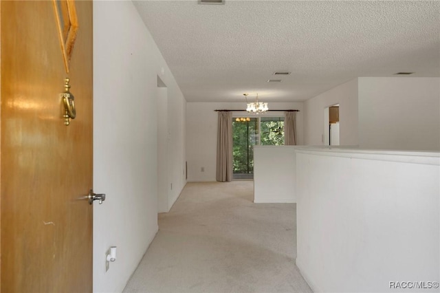6580 E Glencoe St, Inverness, FL 34452 - hall with a chandelier, light colored carpet, and a textured ceiling