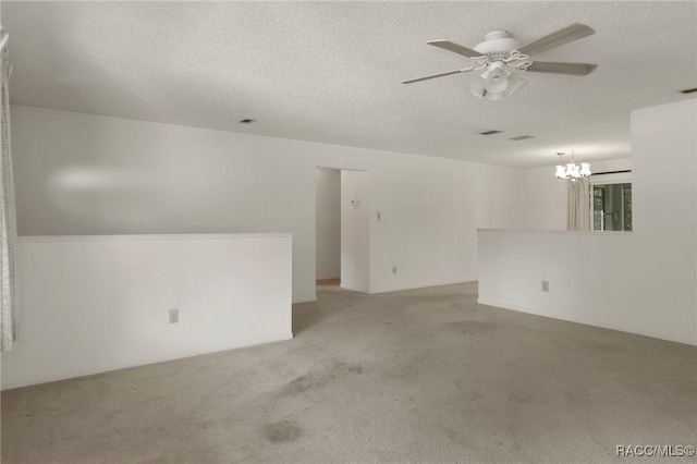 6580 E Glencoe St, Inverness, FL 34452 - unfurnished room featuring light carpet, a ceiling fan, a textured ceiling, and a chandelier