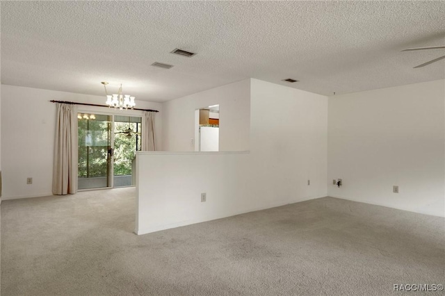 6580 E Glencoe St, Inverness, FL 34452 - empty room with light carpet, a chandelier, ceiling fan, and a textured ceiling