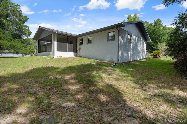 6580 E Glencoe St, Inverness, FL 34452 - rear view of property with a sunroom and a yard
